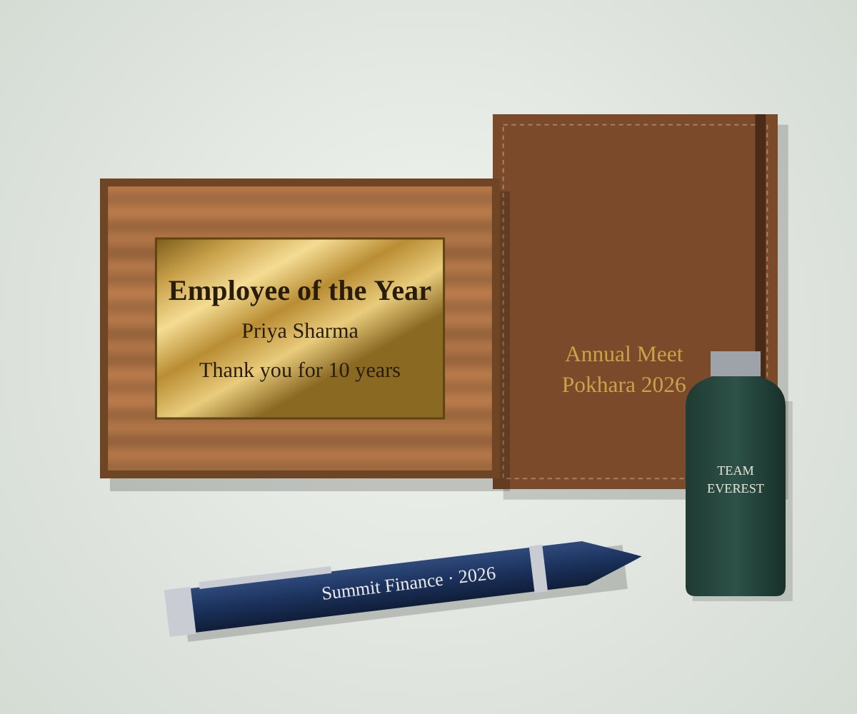 An engraved award plaque, leather notebook, pen and water bottle